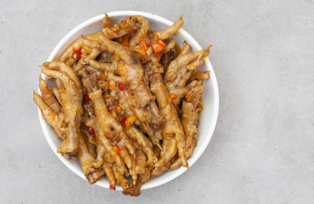 South African township delicacy, cooked chicken feet or walkie talkies with onion and sauce