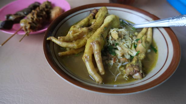 Soto ceker, Indonesian traditional chicken soup with chicken feet on the top, served on the bowl.